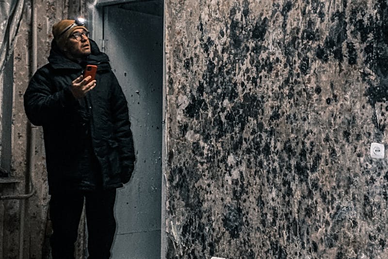 man in a room full f black molds