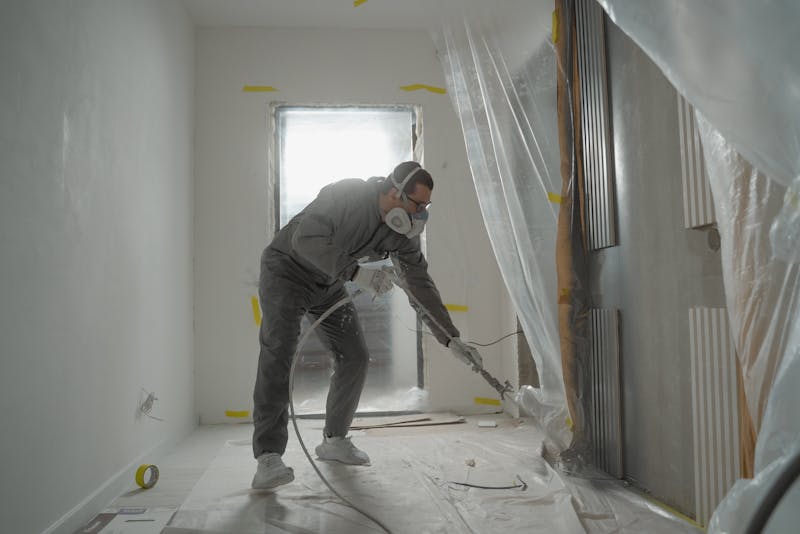 a man cleaning a room that's being worked on